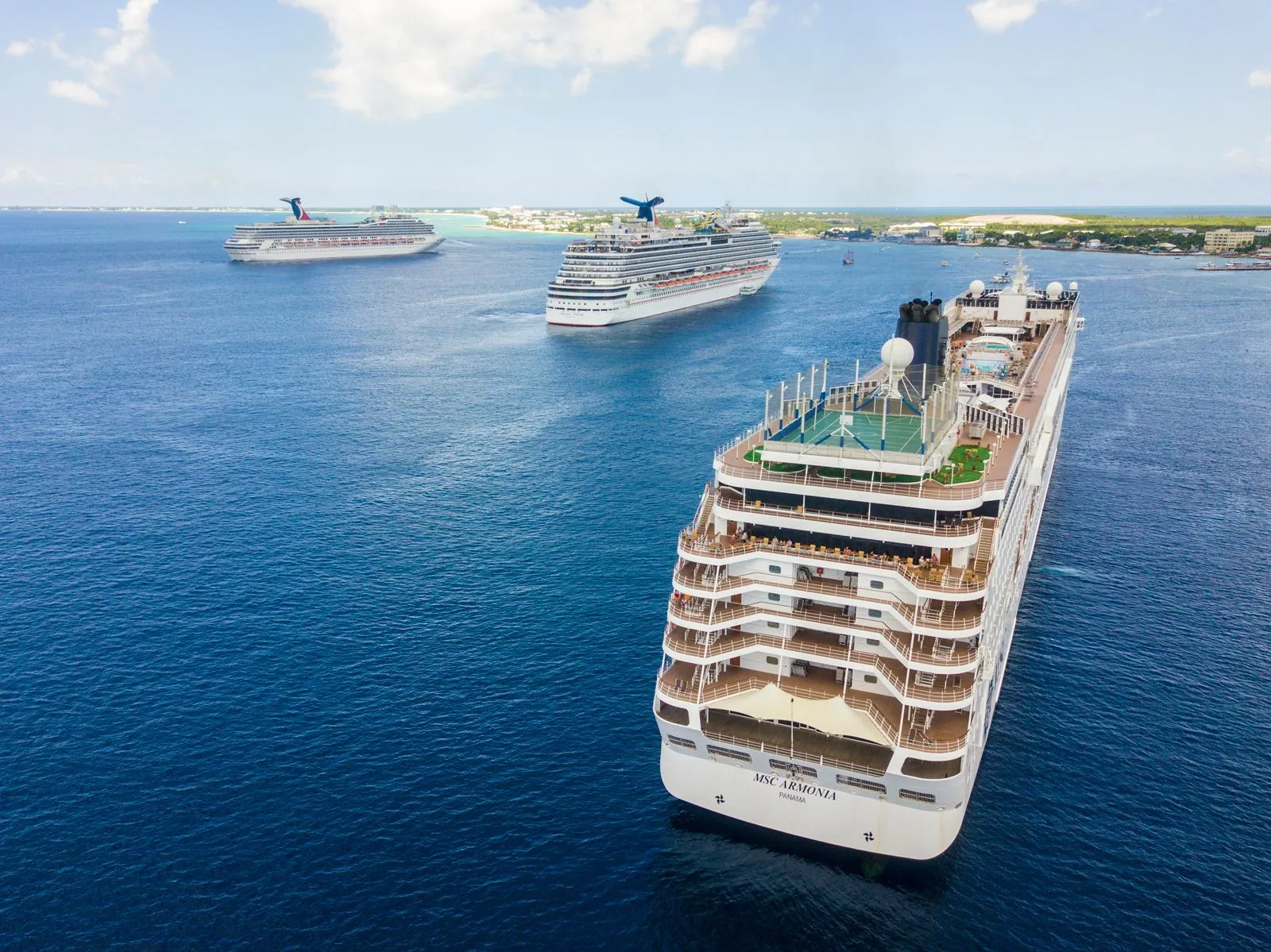 Cruise ships at anchor off a tropical island
