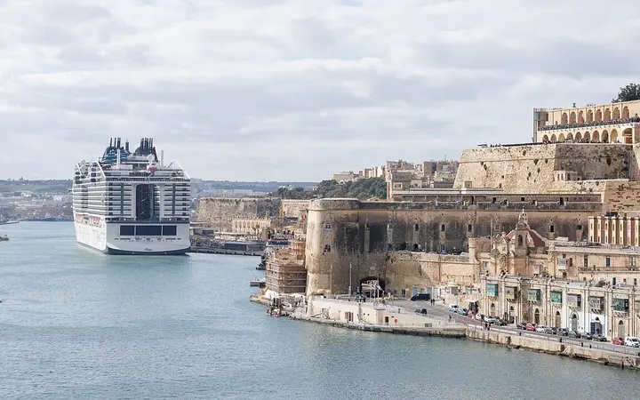Large cruise ship berthed in the Grand Harbour below Valletta's bastions