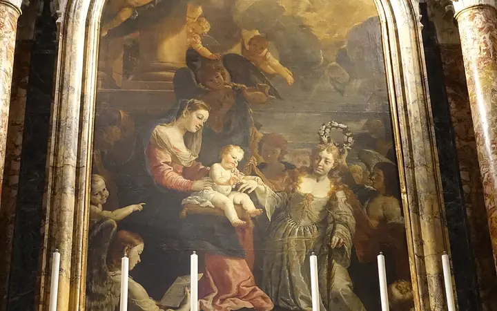 Gilded side altar with a large religious painting inside St John's Co-Cathedral