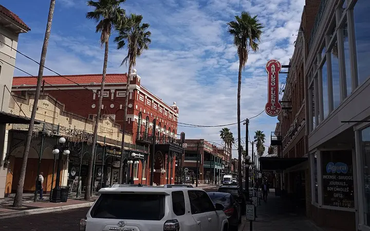 Historic brick buildings and palm trees along 7th Avenue in Ybor City