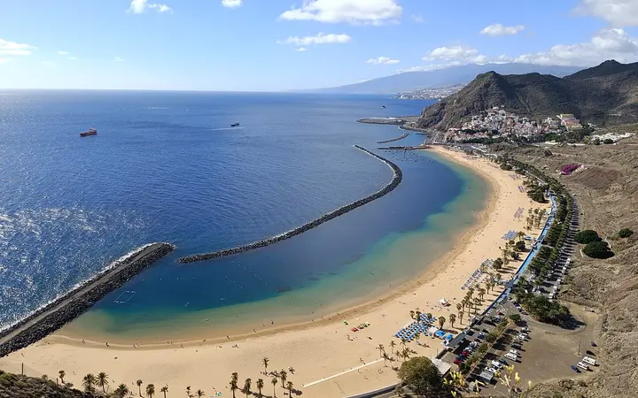 Aerial view of the curving golden Las Teresitas beach and breakwater near San Andrés