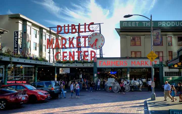 The neon Public Market Center sign and clock at the entrance to Pike Place Market