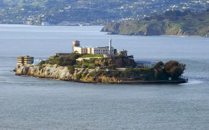Alcatraz Island and its former prison buildings in San Francisco Bay on a clear day
