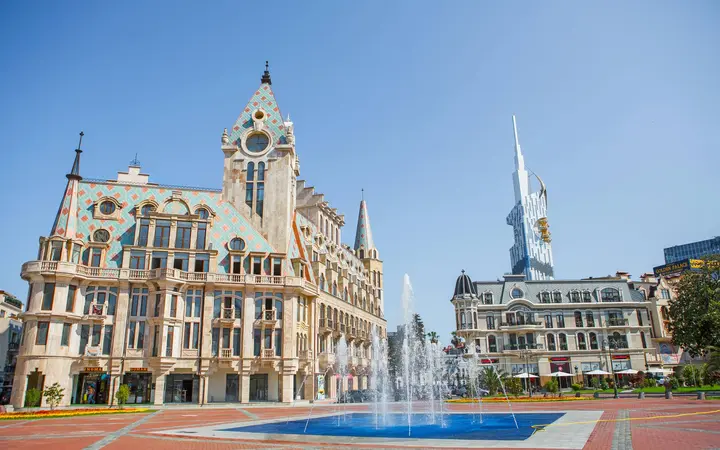 Fountain on Europe Square in Batumi in front of an ornate historic building