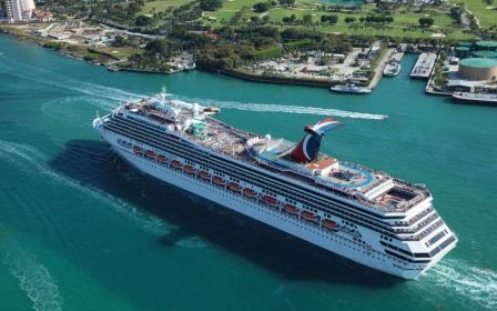 Carnival Glory cruise ship sailing from home port aerial view
